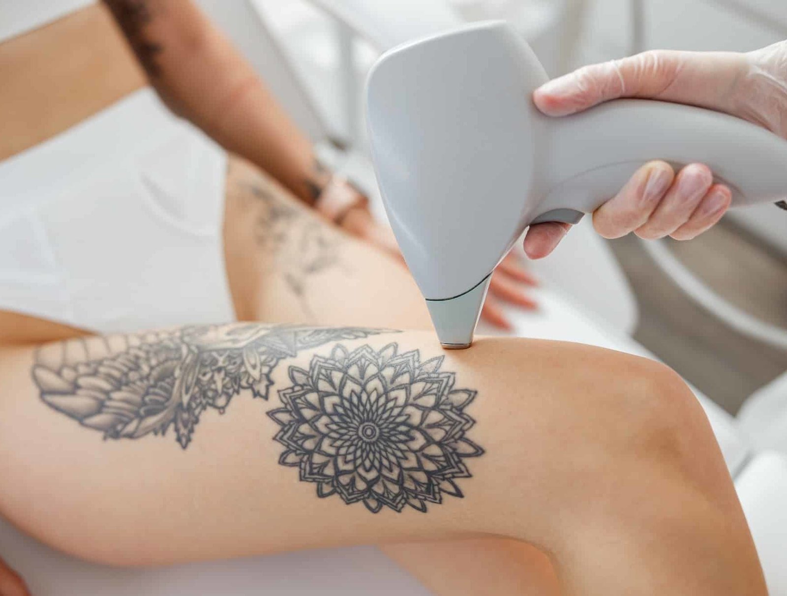 Female cosmetologist performing laser hair removal procedure