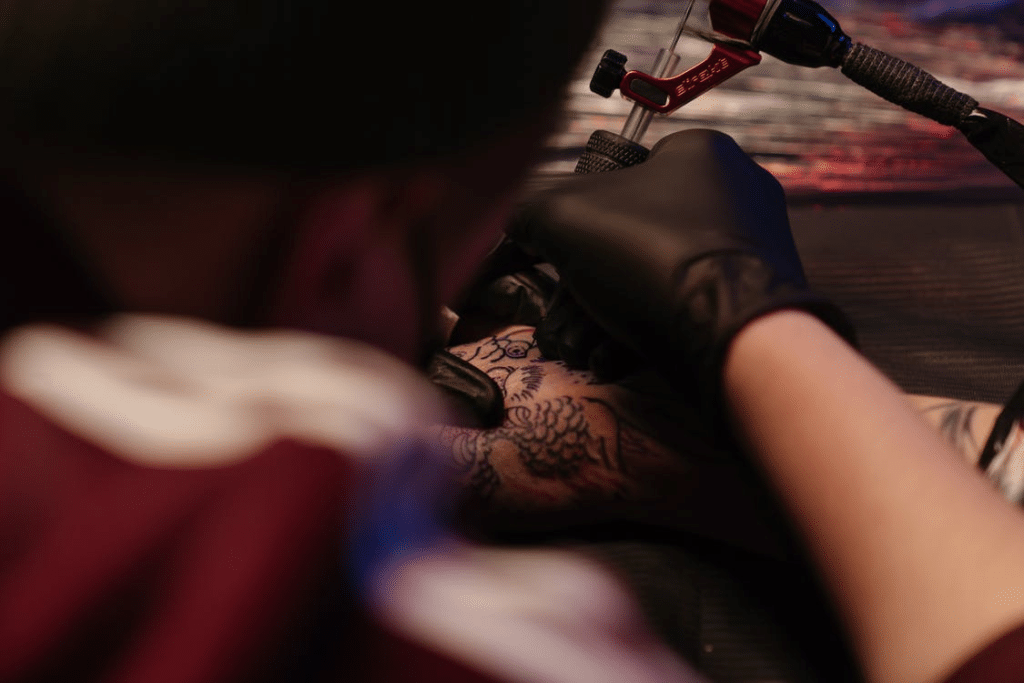 Tattoo Artist making a tattoo on hand