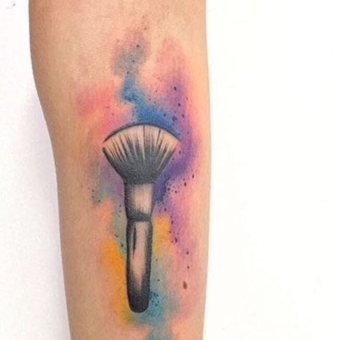 Sprinkling-Makeup-Brush-Tattoo-Design-on-Arm