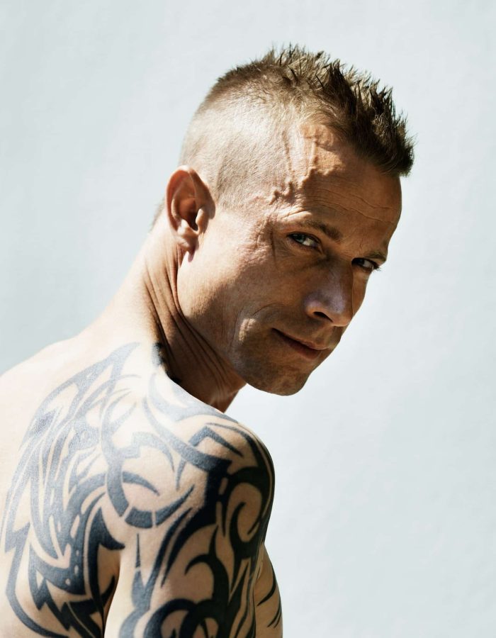Man with tribal tattoo on shoulder