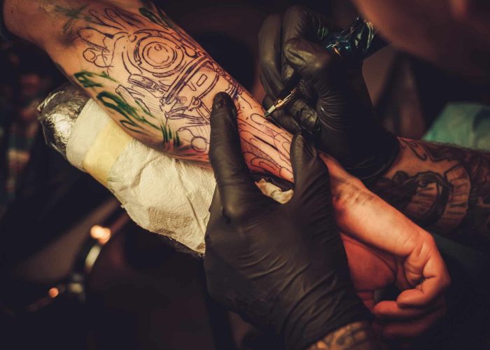 Tattoo artist makes a tattoo on a man's hand, Tattoo And Piercing Studio Forestdale, Tattoo And Piercing Studio Forestdale, Tattoo And Piercing Studio Crystal Palace