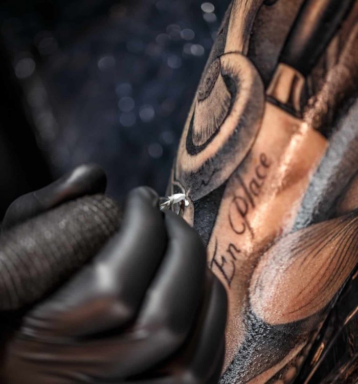 Tattoo artist tattooing