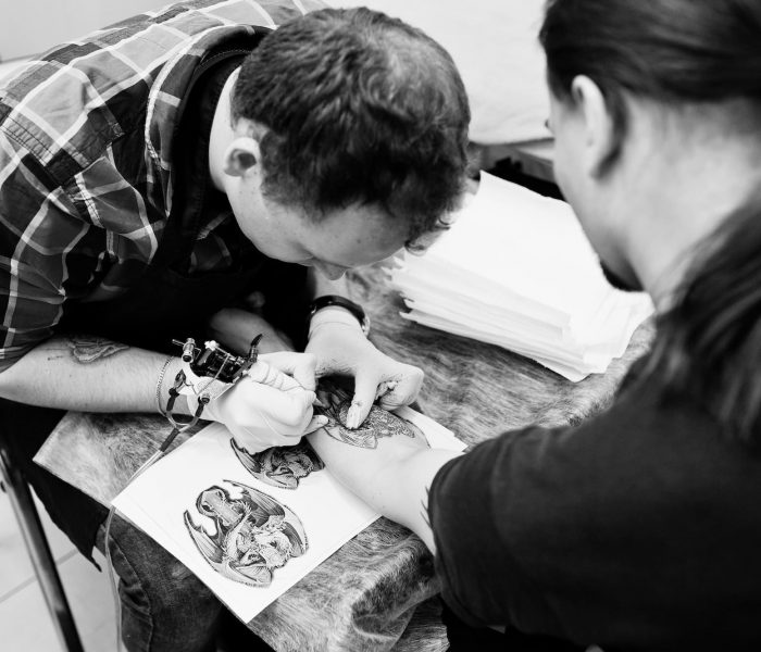 Tattoo master make tattoo for rocker man at tattoo salon, Tribal Tattoo
