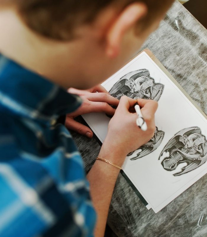 Tattoo master preparing sketch for tattoo