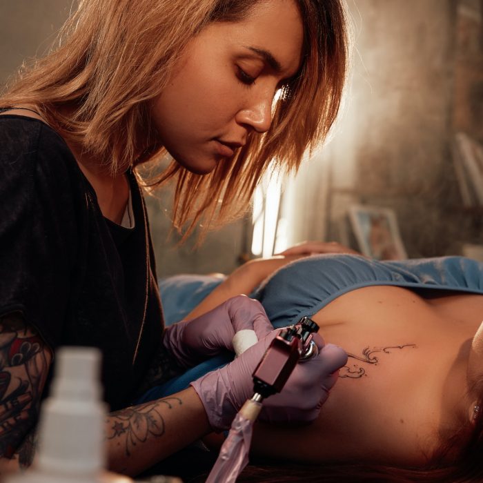Woman came to female tattoo master in room with sunlight