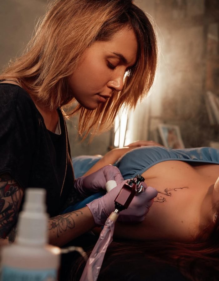 Woman came to female tattoo master in room with sunlight, Mobile Tattoo